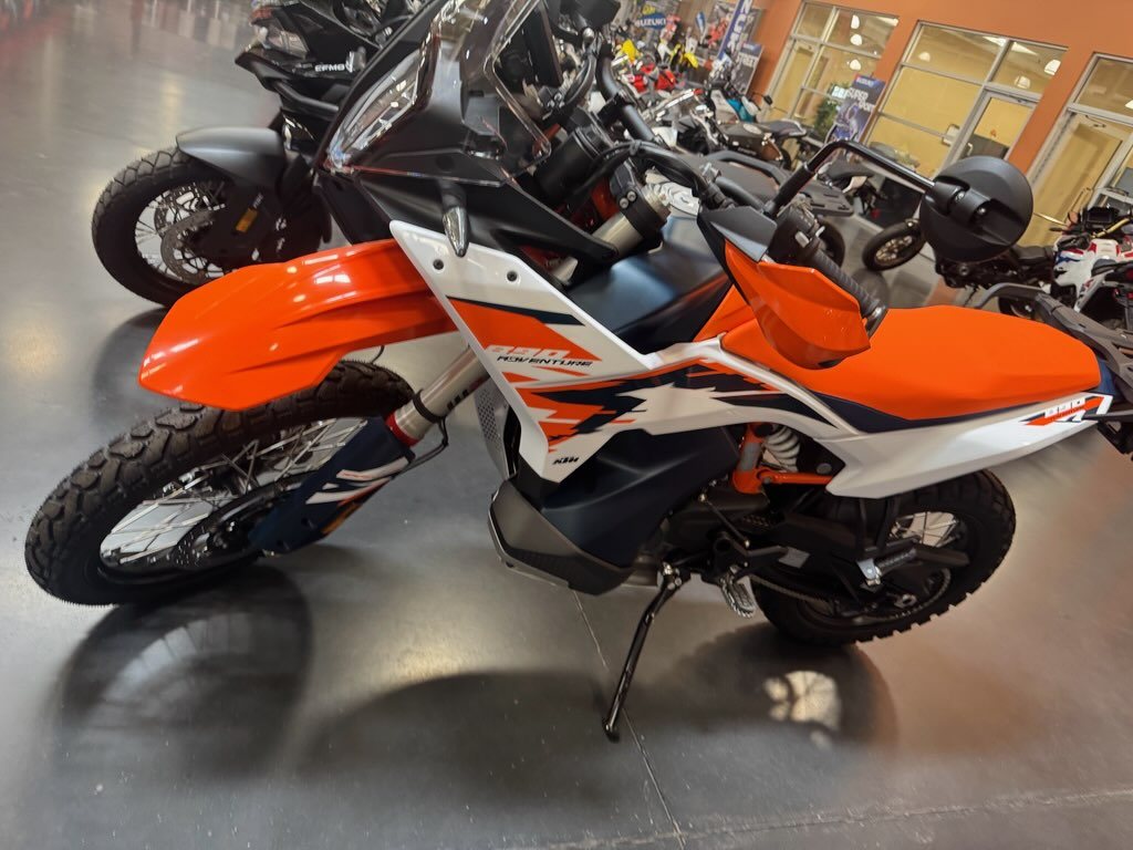 KTM 890 Adventure R front three-quarter view showing orange handguards and high front fender